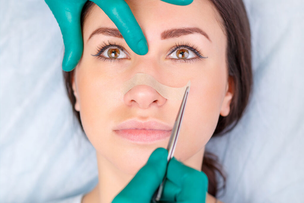 Rhinoplasty surgery consultation focused on patient safety, nasal structure, and treatment planning
