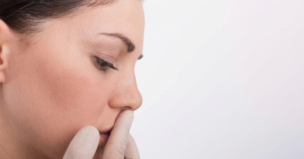 Rhinoplasty patient experiencing breathing problems and nasal blockage after surgery